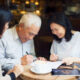 Elder Law Attorney -Elderly Couple and A Lawyer on a table meeting with coffee